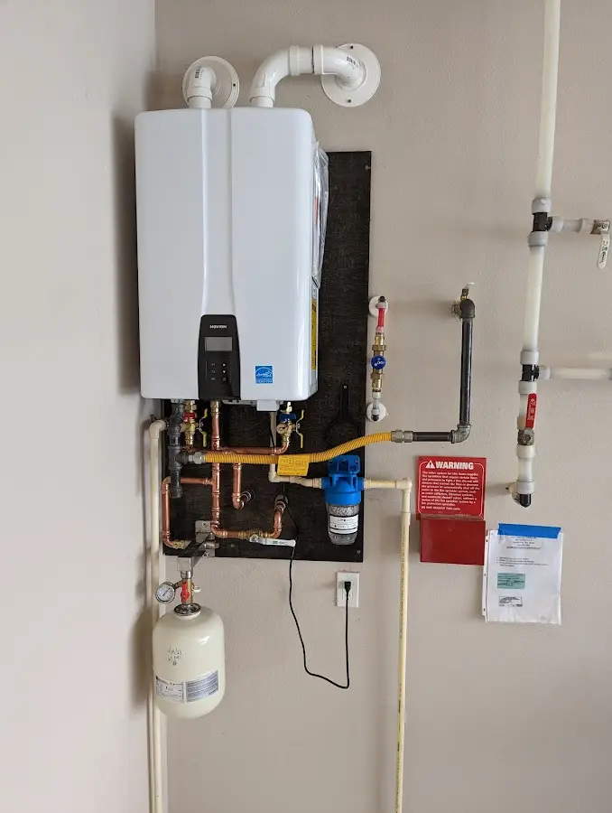 Professional plumber installing copper piping in a State College home